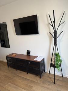 a living room with a coffee table and a flat screen tv at Studio apartman StelLar in Otavice
