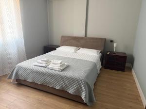 a bedroom with a bed with towels on it at Maya's home Tirana in Tirana