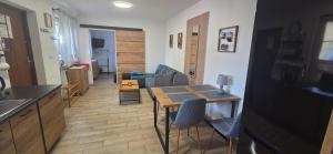 a kitchen and living room with a table and chairs at Apartament Nova Kamienica 1 in Łagów +18 photos