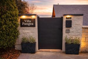 a black garage door with a sign that reads villa panama at VILLA PANGEA - Guest House - Camino del Norte in Castro-Urdiales +4 photos