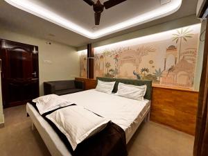 a bedroom with a large bed in a room at ADITI ROOMS in Tiruchirappalli