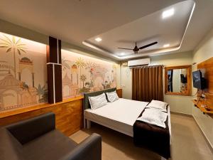 a bedroom with a bed and a chair in it at ADITI ROOMS in Tiruchirappalli