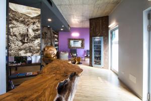 a large wooden table in a room with purple walls at Residence Bleu in San Dorligo della Valle