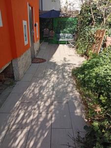 a sidewalk with a bench and an orange building at 4 Apartments Angels o k b in Altenburg