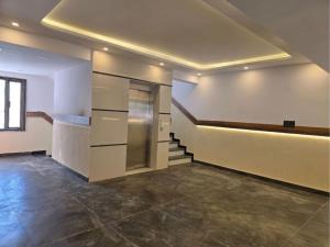 an empty room with a staircase in a building at Hotel Royal Badri - A Pilgrim's Habitat in Badrinath