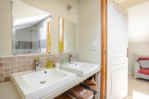 a bathroom with two sinks and a mirror at Maison d'hotes Les Cagouilles in Virson +33 photos