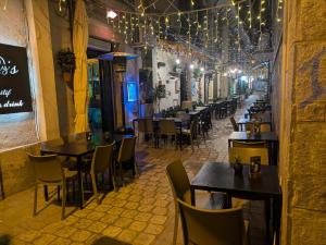 a restaurant with tables and chairs and lights at I Giardini del Caramante in Soverato Marina