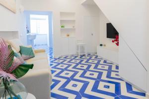 a living room with a blue and white patterned floor at Isabel Luxury Suite in Ischia