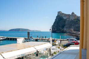 a view of a marina with a castle in the background at Isabel Luxury Suite in Ischia