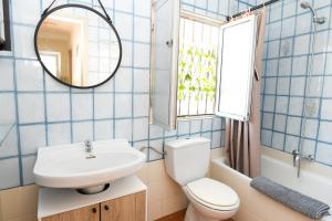 a bathroom with a sink and a toilet and a mirror at Casa Marzoa in Finisterre