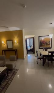 a living room with a couch and a table at ALOHA ON SACRED GANGES 2BHK Premium Ganga View Apartment with Infinity Pool in Rishīkesh