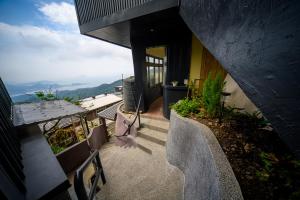 a set of stairs leading to a house with a view at 九份觀海樓民宿 in Jiufen