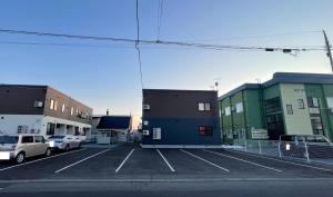 a view of a parking lot with cars parked at T-square旭大前I in Asahikawa