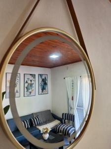 a living room with a couch and a mirror at Rincón Esmeralda in Mercedes