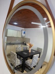 a mirror reflecting a table and chairs in a kitchen at Rincón Esmeralda in Mercedes