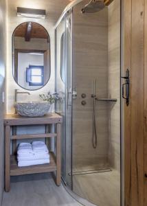 a bathroom with a shower and a sink at Marketos Windmill House in Tripiti +30 photos