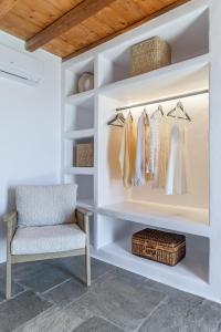 a dressing room with a chair and a shelf at Marketos Windmill House in Tripiti
