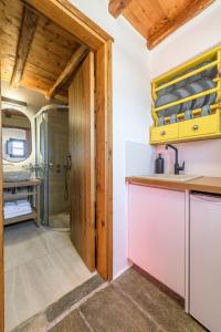 a kitchen with a shower and a sink at Marketos Windmill House in Tripiti
