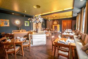 a restaurant with tables and chairs in a room at Hotel Saxenhof der Rhöner Botschaft in Dermbach +34 photos
