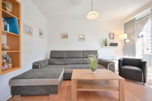 a living room with a couch and a coffee table at Ferienhaus Keona Im Winkel in Dahme +20 photos