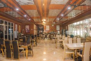 a restaurant with tables and chairs in a room at MIK Resort & Hotel in Pasuruan