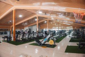 a gym with a lot of treadmills and exercise bikes at MIK Resort & Hotel in Pasuruan