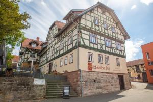 a building with a sign on the side of it at Hotel Saxenhof der Rhöner Botschaft in Dermbach