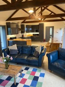 a living room with a blue couch and a table at Housegarth in Twatt
