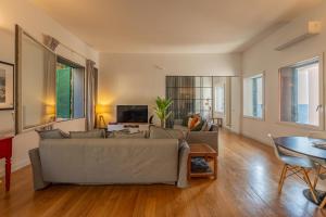 a living room with a couch and a table at LOFT sull'acqua con vista mozzafiato in Naples