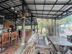 a restaurant with wooden tables and benches in a room at Moonlit Garden Koh Chang in Ban Dan Kao +90 photos