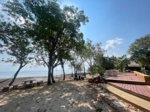 a park with benches and trees on the beach at Moonlit Garden Koh Chang in Ban Dan Kao