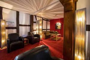 a living room with a couch and chairs in a room at Hotel Saxenhof der Rhöner Botschaft in Dermbach