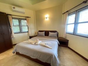 a bedroom with two beds with towels on the bed at Moonlit Garden Koh Chang in Ban Dan Kao