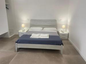 a bedroom with a bed with two towels on it at B&B Sparta in Crotone