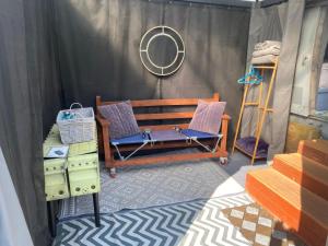 a room with a bench and a mirror at Haelarcher Helicopter Glamping in Helston