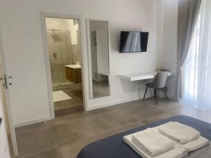 a white bathroom with a sink and a mirror at B&B Sparta in Crotone