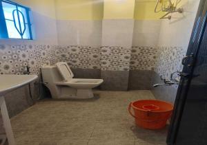 a bathroom with a toilet and a sink at Golf View Residency in Shillong