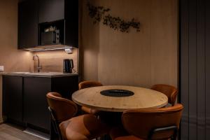 a kitchen with a table and chairs and a sink at Aurora Lake Lodges in Ranua