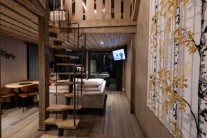 a room with a bunk bed and a spiral staircase at Aurora Lake Lodges in Ranua