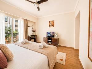 a bedroom with two beds and a television in it at Marina Executive Suites in Agadir +56 photos