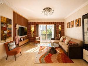 a living room with a couch and a tv at Marina Executive Suites in Agadir