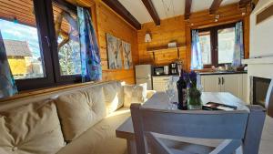 a living room with a couch and a table at Chatka Kudłatka in Wetlina