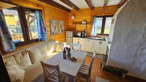 a kitchen with a table and a couch in a room at Chatka Kudłatka in Wetlina +36 photos