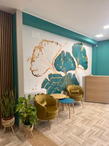 a waiting room with chairs and a wall with a mural at Da Delfina Affittacamere in Anzio