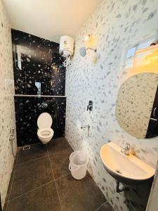 a bathroom with a toilet and a sink and a mirror at Villa Govindaraj in Pondicherry +24 photos