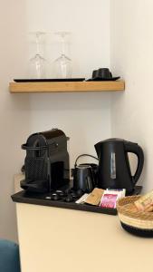 a kitchen counter with a stove top with pots and pans at DuOr Suite & Rooms in Polignano a Mare
