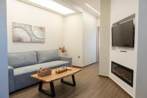 a living room with a couch and a tv at Antaia 4 in Nafplio