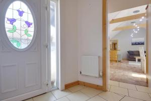a hallway with a door with a stained glass window at The Stables Hill Top Farm in Haselbury Bryan