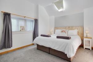 a bedroom with a large bed and a window at The Stables Hill Top Farm in Haselbury Bryan +21 photos