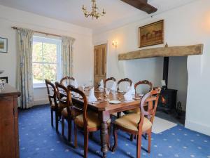 a dining room with a wooden table and chairs at Gould's Farmhouse in Blandford Forum